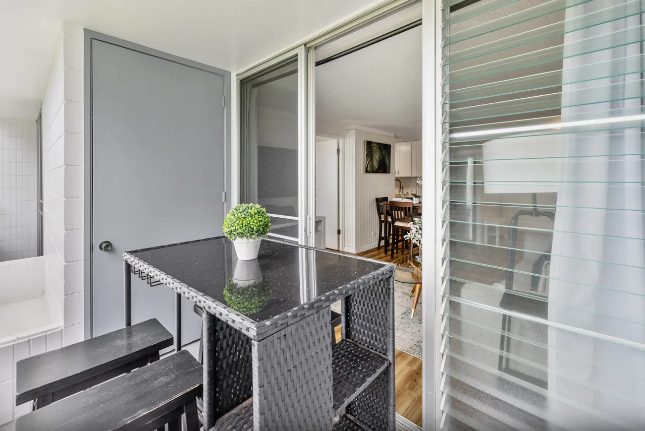 Entry with mirrored closet doors opening to the dining area