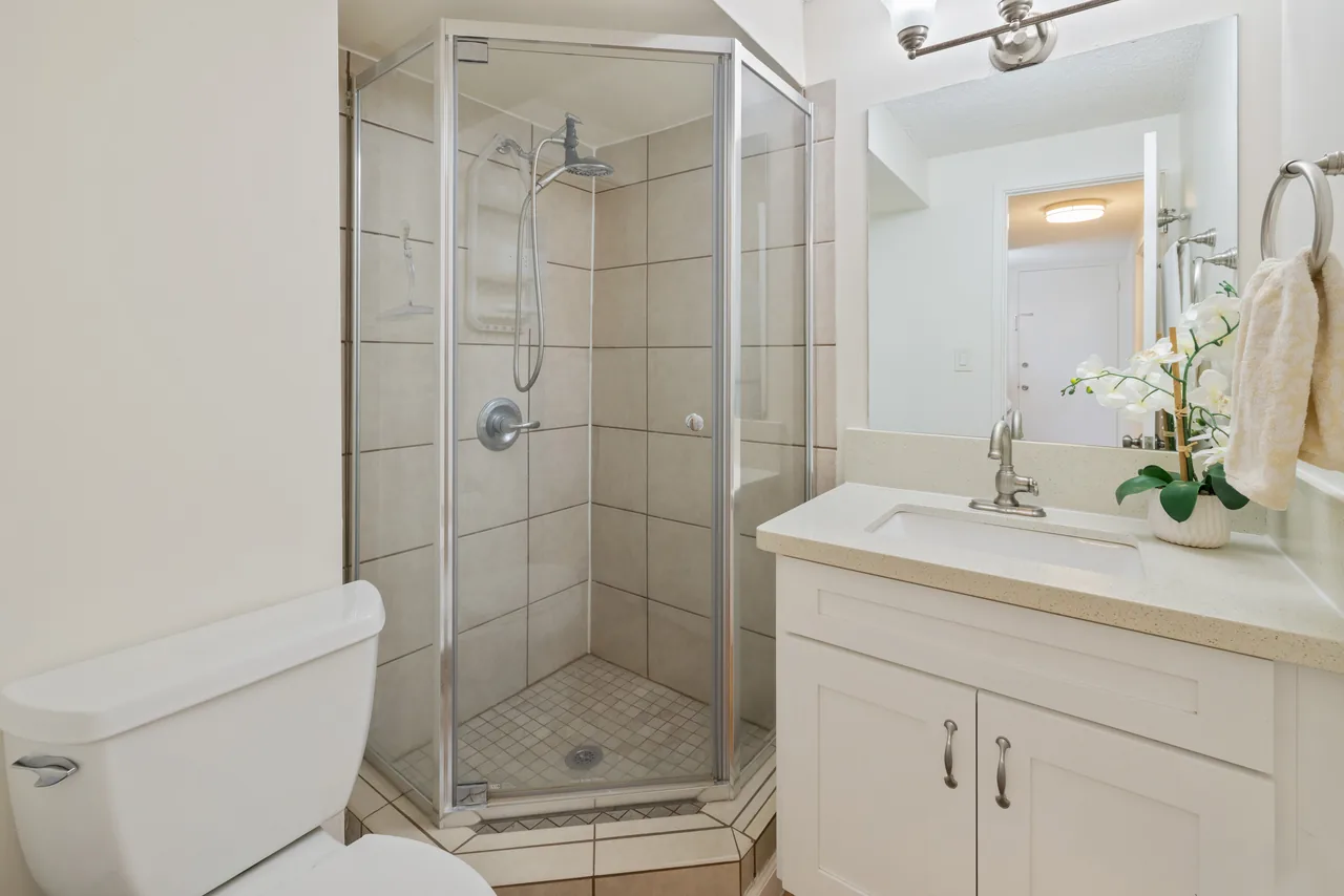 Bathroom with a glass-enclosed shower and vanity