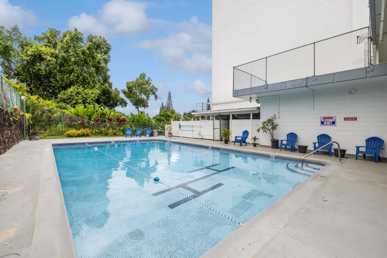 Community swimming pool with poolside lounge seating
